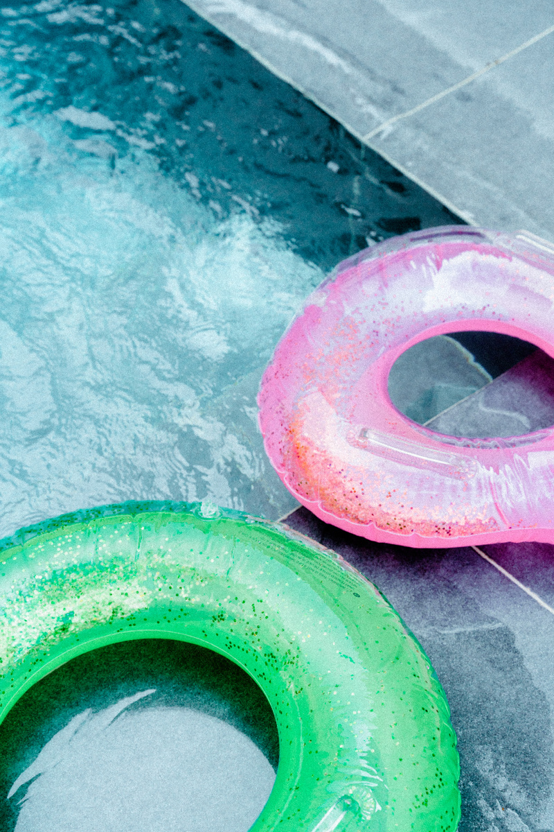 Pink and Green Inflatable Rings on the Pool 